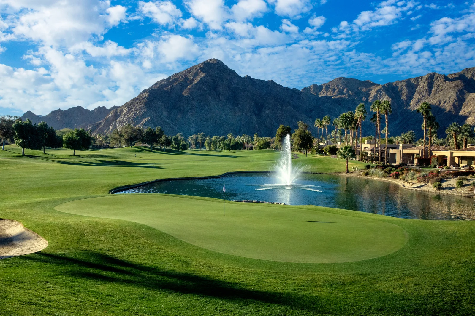 Golf green and fountain beneath the mountains at Indian Wells Country Club